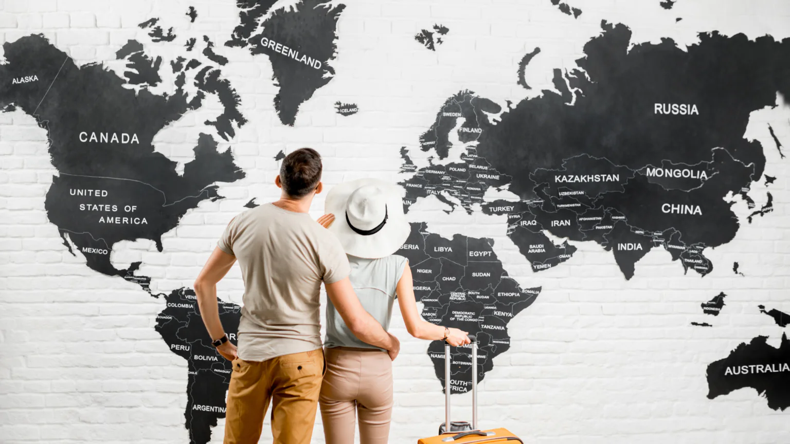 Couple looking at world map